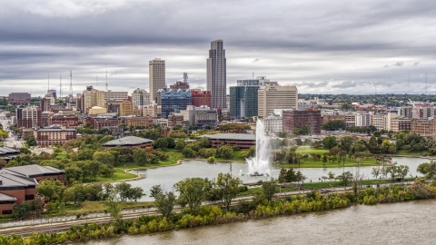 DXP002_169_0009 - Aerial stock photo of The city's skyline while seen from near a park fountain, Downtown Omaha, Nebraska