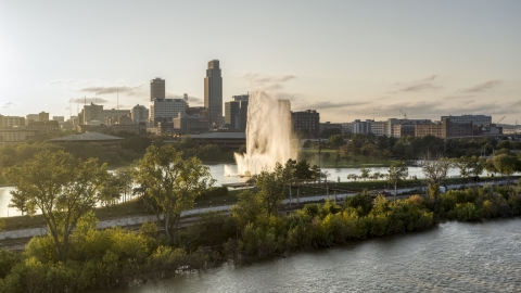 A fountain and riverfront park with view of skyline at sunset, Downtown Omaha, Nebraska Aerial Stock Photos | DXP002_172_0003