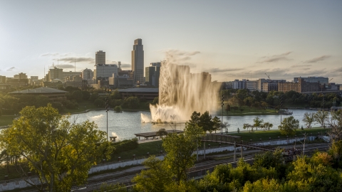 DXP002_172_0004 - Aerial stock photo of A view of a fountain with view of skyline at sunset, Downtown Omaha, Nebraska