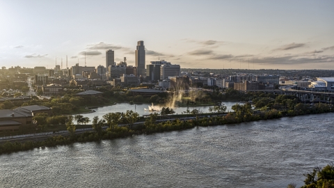 DXP002_172_0005 - Aerial stock photo of A fountain with view of skyline at sunset, Downtown Omaha, Nebraska