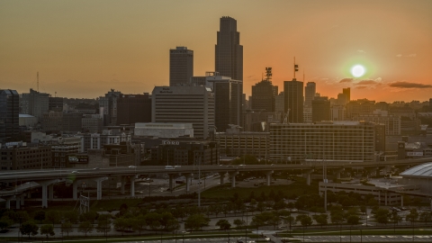 DXP002_172_0010 - Aerial stock photo of A skyscraper and skyline with view of setting sun, Downtown Omaha, Nebraska