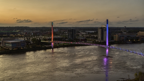 A colorful pedestrian bridge spanning the Missouri River at twilight, Omaha, Nebraska Aerial Stock Photos | DXP002_172_0017