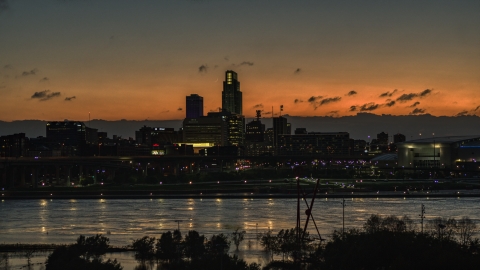 A view over the river toward the skyline at twilight, Downtown Omaha, Nebraska Aerial Stock Photos | DXP002_173_0001