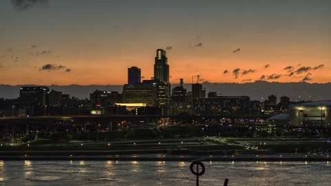 A view across the river toward the skyline at twilight, Downtown Omaha, Nebraska Aerial Stock Photos | DXP002_173_0002