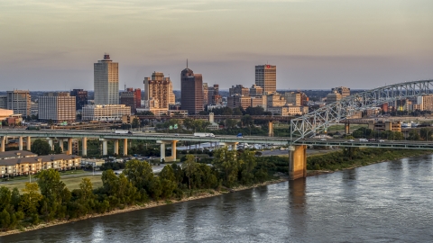 DXP002_181_0002 - Aerial stock photo of The city's skyline behind the bridge at sunset, Downtown Memphis, Tennessee