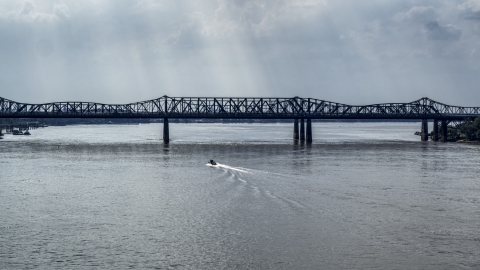 DXP002_183_0006 - Aerial stock photo of A boat speeding across the Mississippi River toward Harahan Bridge, Memphis, Tennessee