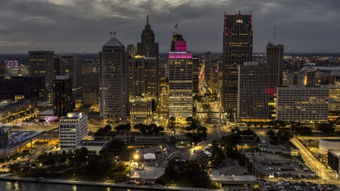 A view of tall downtown skyscrapers at twilight seen from the river, Downtown Detroit, Michigan Aerial Stock Photos | DXP002_193_0003