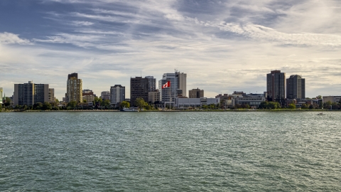 Office buildings and Canadian flag by the river in Windsor, Ontario, Canada Aerial Stock Photos | DXP002_196_0003