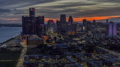 Giant skyscrapers at twilight in Downtown Detroit, Michigan Aerial Stock Photos | DXP002_198_0003