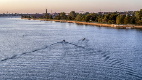 DXP002_204_0004 - Aerial stock photo of A rowboat and speedboat on Lake Erie at sunset, Buffalo, New York