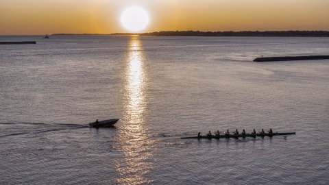 DXP002_204_0005 - Aerial stock photo of A view of Lake Erie as a rowboat and speedboat pass at sunset, Buffalo, New York