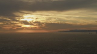 5K aerial stock footage of a view across Los Angeles at the sunset behind clouds, California Aerial Stock Footage | AF0001_000982