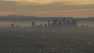 AF0001_000984 - 5K aerial stock footage of the Downtown Los Angeles skyline at a hazy sunset, California