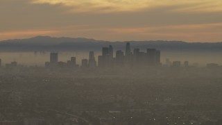 5K aerial stock footage of a view of the Downtown Los Angeles skyline in haze at sunset, California Aerial Stock Footage | AF0001_000985