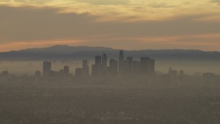 5K aerial stock footage of passing the Downtown Los Angeles skyline in haze at sunset, California Aerial Stock Footage | AF0001_000986