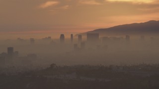 5K aerial stock footage of Century City skyscrapers in haze at sunset, California Aerial Stock Footage | AF0001_000993