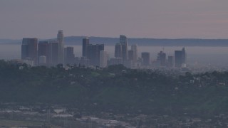 5K aerial stock footage of Downtown Los Angeles skyline behind hilltop Echo Park homes at twilight, California Aerial Stock Footage | AF0001_001002