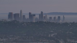 5K aerial stock footage of Downtown Los Angeles skyline behind hilltop Silver Lake homes at twilight, California Aerial Stock Footage | AF0001_001003