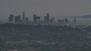 5K aerial stock footage of a view of Downtown Los Angeles skyline and hillside homes in Silver Lake at twilight, California Aerial Stock Footage | AF0001_001004