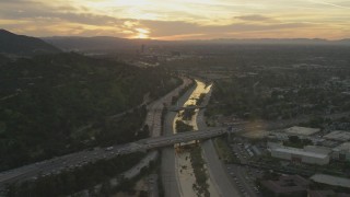 5K aerial stock footage of heavy traffic on 134 and I-5 by the Los Angeles River and neighborhoods at sunset, Burbank, California Aerial Stock Footage | AF0001_001007