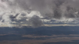 8K aerial stock footage of gray clouds over desert and mountain ridges in Southern California Aerial Stock Footage | AF0001_001016