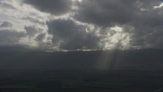 8K aerial stock footage of godrays shining down on farm fields in Southern California Aerial Stock Footage | AF0001_001025