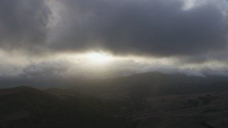 8K aerial stock footage of thick clouds over dry hills  at sunset in Southern California Aerial Stock Footage | AF0001_001026