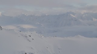 4K aerial stock footage reveal snow-covered Chugach Mountains, clouds, Chugach National Forest, Alaska Aerial Stock Footage | AK0001_0009