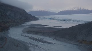 AK0001_0048 - 4K aerial stock footage flying low over river flowing into lake, near glacier, Knik, Alaska