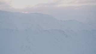 4K aerial stock footage flying over snowy peaks, low clouds, Chugach Mountains, Alaska Aerial Stock Footage | AK0001_0075