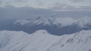 4K aerial stock footage snow capped Chugach Mountains, clouds, Chugach Mountains, Alaska, sunset Aerial Stock Footage | AK0001_0077