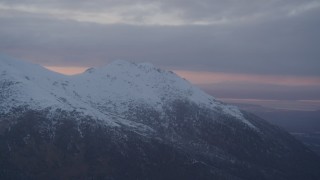 4K aerial stock footage flyby by snow capped mountain peak, Chugach Mountains, Alaska, sunset Aerial Stock Footage | AK0001_0088