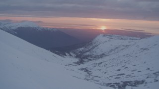 4K aerial stock footage approaching Anchorage, seen from Chugach Mountains, Alaska, sunset Aerial Stock Footage | AK0001_0091