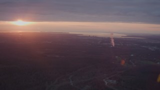 4K aerial stock footage pan across Anchorage, power plant, reveal setting sun, Anchorage, Alaska, sunset Aerial Stock Footage | AK0001_0097