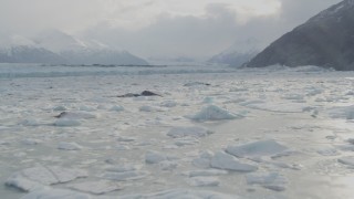 AK0001_0113 - 4K aerial stock footage flying low over Knik River, approaching Chugach Mountains, Knik Glacier, Alaska