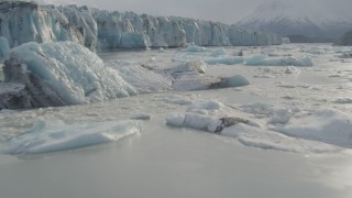 AK0001_0122 - 4K aerial stock footage flying low over icy Knik River near Knik Glacier, Alaska