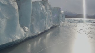 AK0001_0126 - 4K aerial stock footage flying low over Knik River, along the edge of Knik Glacier, Alaska