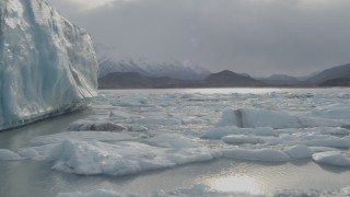 AK0001_0127 - 4K aerial stock footage flying low over icy Knik River near Knik Glacier, Alaska