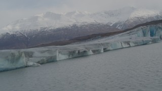 AK0001_0130 - 4K aerial stock footage flying low over Knik River, pan left revealing Knik Glacier, Alaska