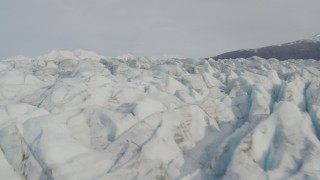 AK0001_0133 - 4K aerial stock footage flying low over Knik Glacier, approach Chugach Mountains, Knik Glacier, Alaska