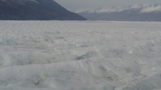 4K aerial stock footage flying low over Knik Glacier, approaching Chugach Mountains, Knik Glacier, Alaska Aerial Stock Footage | AK0001_0135