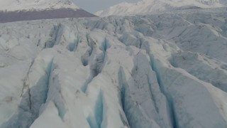 4K aerial stock footage flying low over Knik Glacier, tilt down to surface of the glacier, Knik Glacier, Alaska Aerial Stock Footage | AK0001_0140