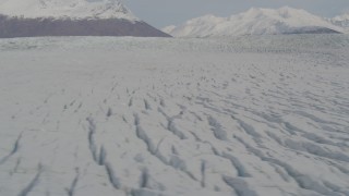 4K aerial stock footage fly over surface of Knik Glacier, reveal Chugach Mountains, Knik Glacier, Alaska Aerial Stock Footage | AK0001_0142