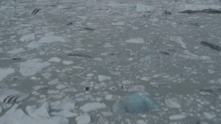 4K aerial stock footage tilting up from icy river running near foothills, Knik River, Alaska Aerial Stock Footage | AK0001_0147