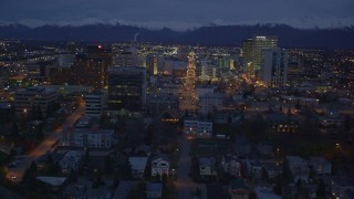 AK0001_0156 - 4K aerial stock footage revealing Hotel Captain Cook, Downtown Anchorage, Alaska, night