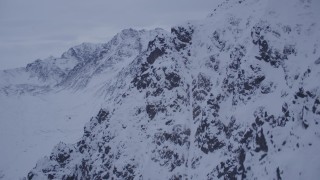 4K aerial stock footage fly over summit toward a snow covered range, Chugach Mountains, Alaska, sunset Aerial Stock Footage | AK0001_0188