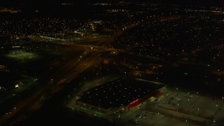 4K aerial stock footage tilt up from intersection, following freeway and revealing Anchorage, Alaska, night Aerial Stock Footage | AK0001_0198