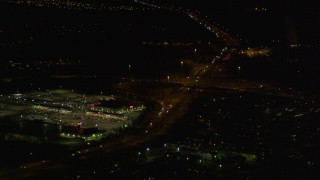 4K aerial stock footage flying by shopping center, tilt up following Glenn Highway, Anchorage, Alaska, night Aerial Stock Footage | AK0001_0199