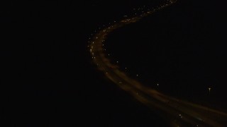 4K aerial stock footage following Glenn Highway, tilt up to Anchorage, Alaska, night Aerial Stock Footage | AK0001_0203