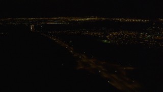 4K aerial stock footage following Glenn Highway, tilt up to Anchorage, Alaska, night Aerial Stock Footage | AK0001_0205